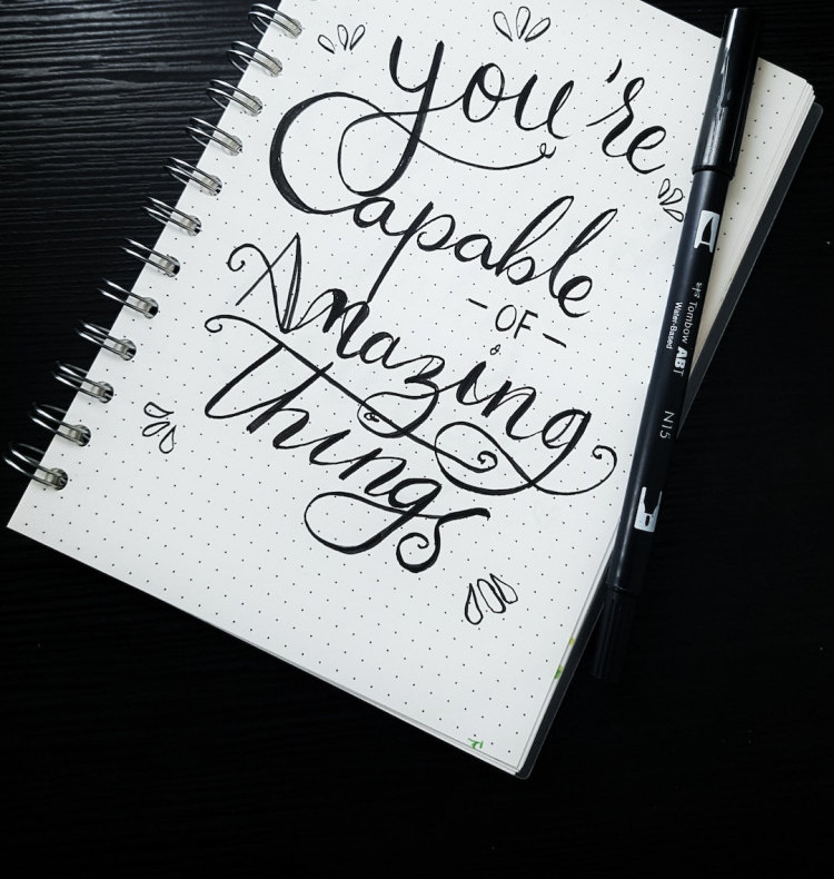 The key to contentment is gratitude - a notebook with a sentence : You are capable of Amazing things