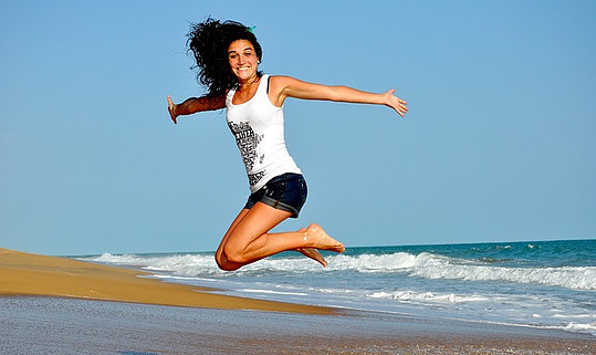 manifesting money affirmations: a woman is jumping high