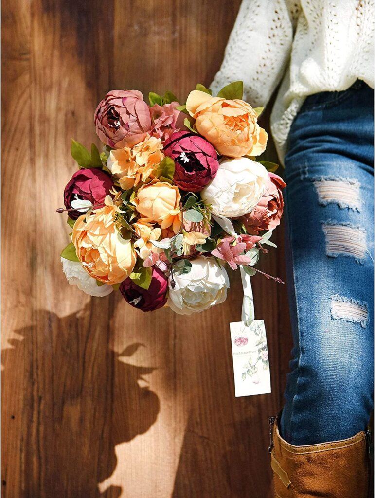 French country cottage decorating ideas: a girl is holding a bouquet of flowers