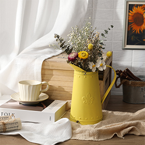 French country cottage decorating ideas: a yellow vase with flowers next to books