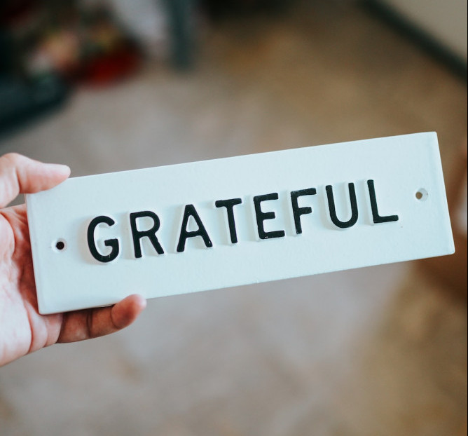 The key to contentment is gratitude - a white board with the word " Gratitude" on it