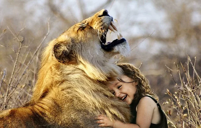 The scientific benefits of hugs: a girl is hugging a lion