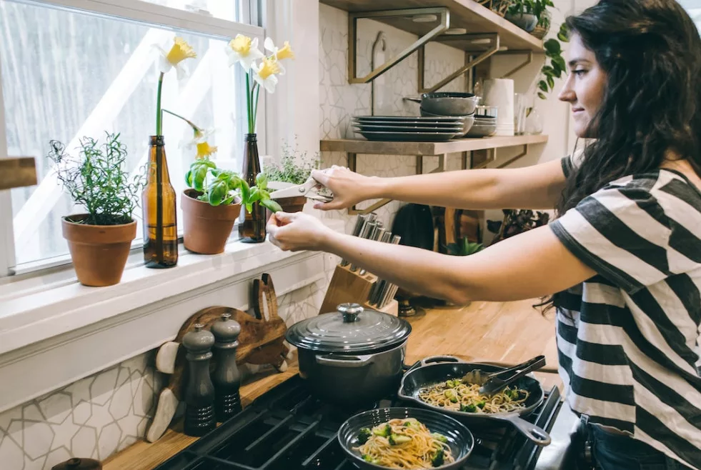 10 healthy ways to relieve stress: a woman is cooking a meal