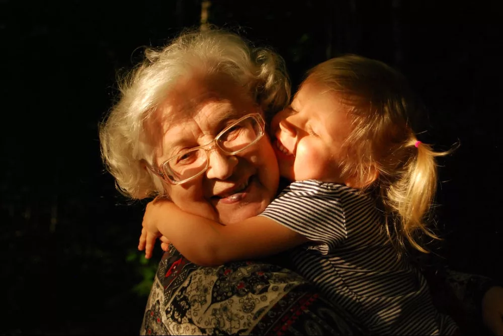 The scientific benefits of hugs: a child is hugging her grandma