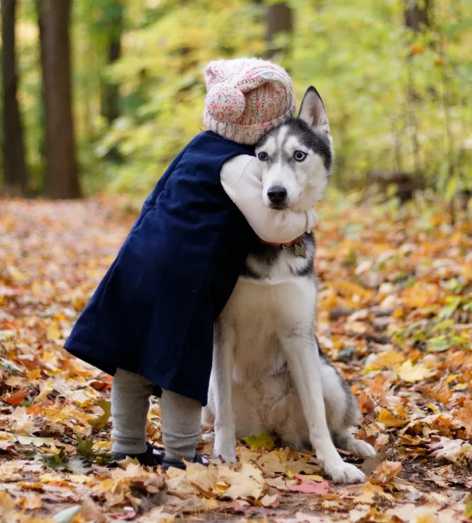 The scientific benefits of hugs: a girl is hugging her dog