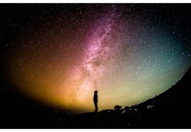 Neville Goddard and The Law of Assumption: picture of man standing under a night sky