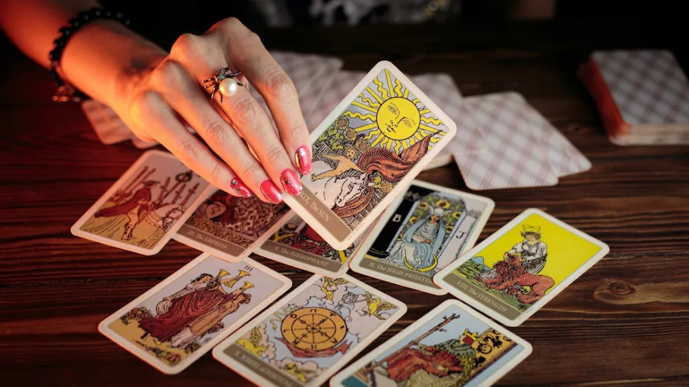 How to read tarot cards for beginners: a person is holding a tarot card