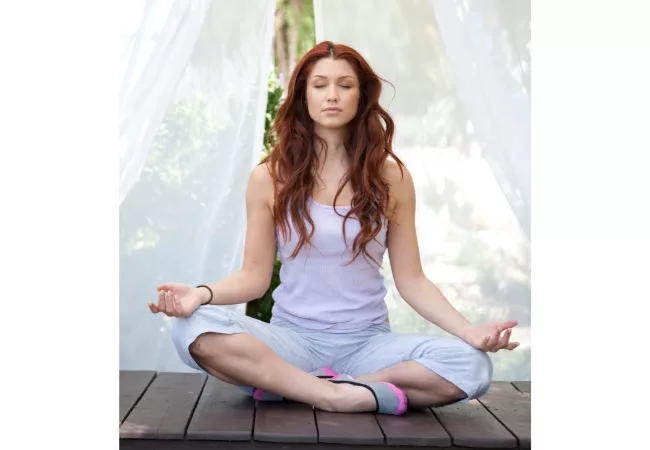 Basic meditation techniques for beginners: a woman is meditating