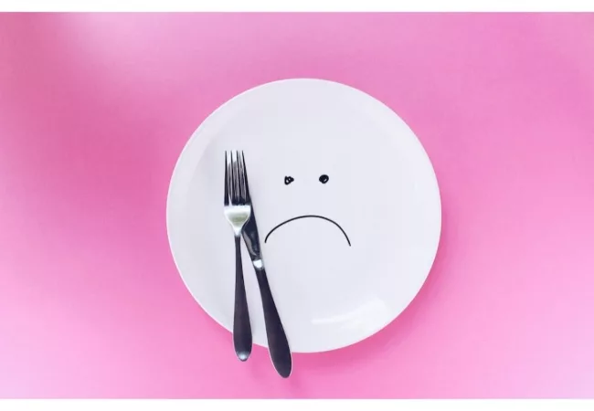 The Law of Attraction on Weight Loss: a plate with a sad emoji