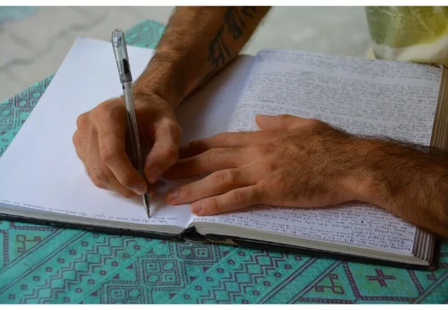 how to start gratitude journaling: a man is writing his diary